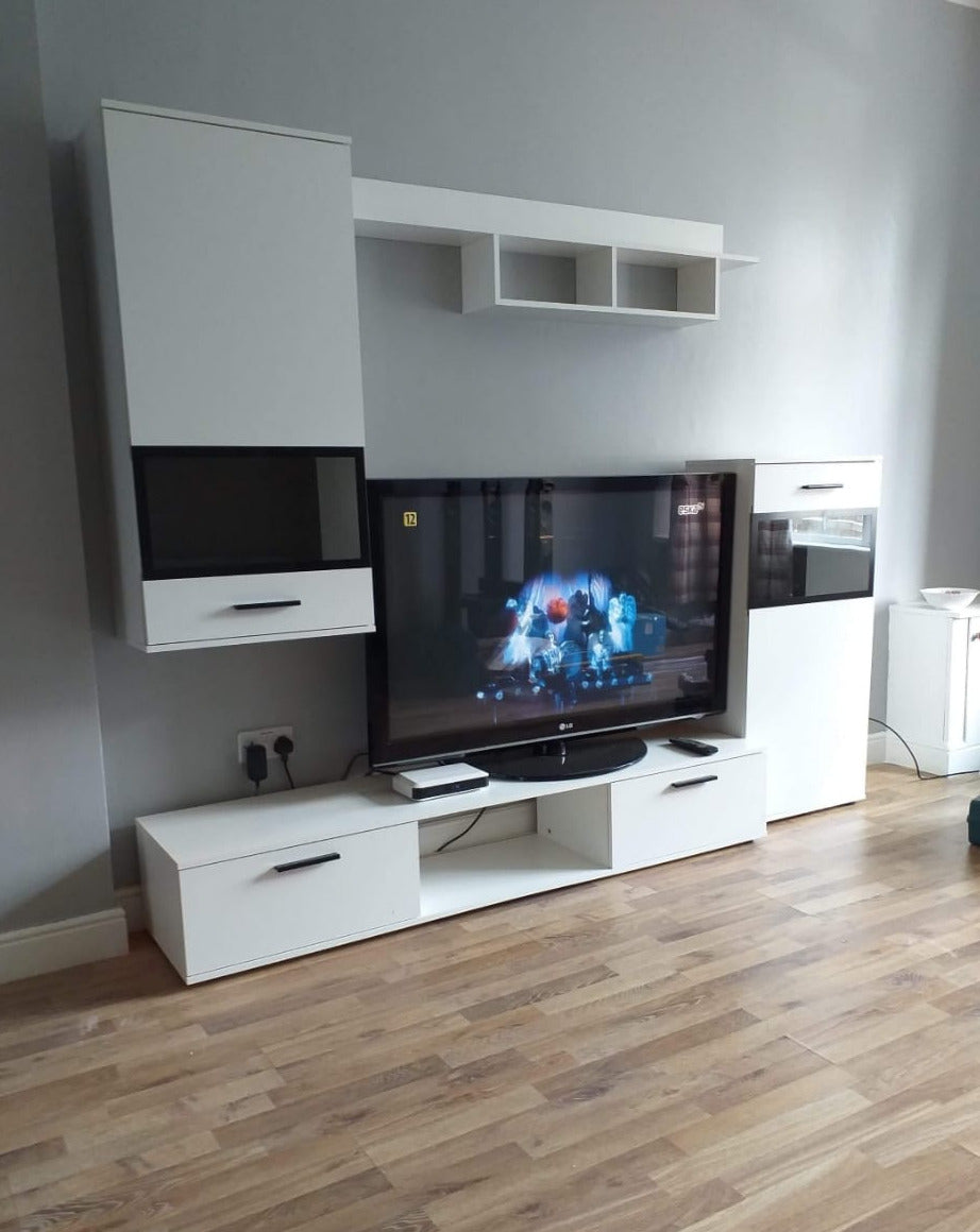 TV WALL UNIT MAXI WhiteOverall dimensions of the wall unit: 2300 x 2000 x 402mm (W x H x D)Number of packages: 2Front:- 15mm white laminated board- melamine rim- glass with a black print- handle: 128mm plasticBody:- 15mm white laminated board- melamine ri