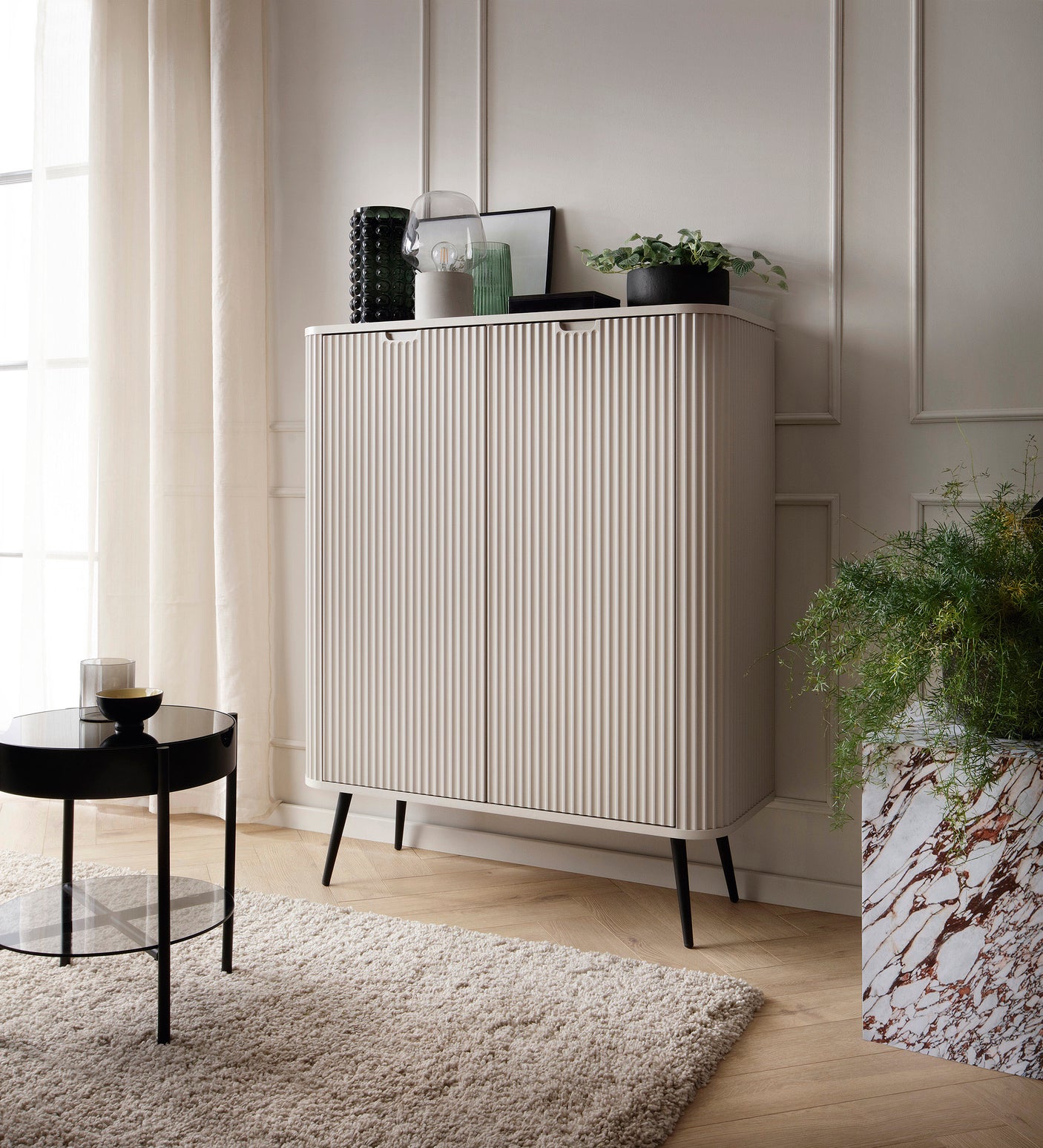 Storage cabinet ZOVA 03 CASHEMEREProduct description Dimensions Width 103cm Height 129cm Depth 39cm Details Colour cashmere Material Laminated board 18mm / MDF-board 18mm Veneer ABS edges Legs Metal, in black (23cm) Warranty 24 monthsUncategorizedAnna Fur